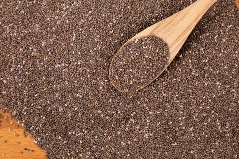 Chia seeds with wooden spoon Stock Photos