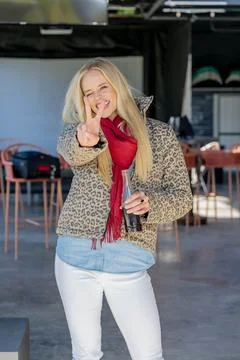 Chic and Radiant: Blonde Beauty Embraces Sun and Soda at Vibrant Open-Air Mal Stock Photos