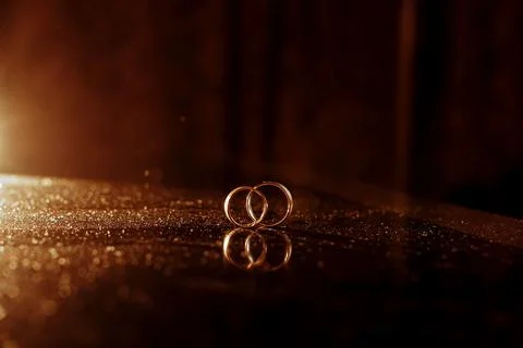 Chic gold rings close-up on the table of the newlyweds Stock Photos