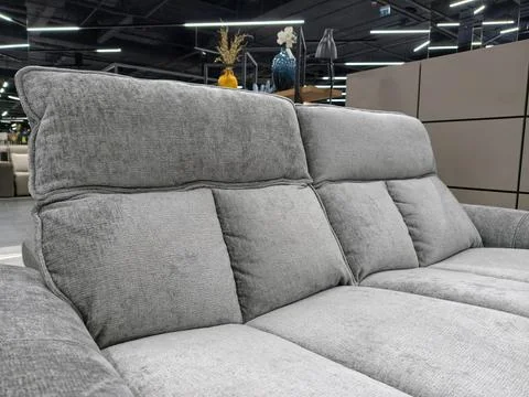 A chic gray divan, ideal for any living room, for sale in a furniture store Stock Photos