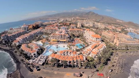 Chic hotels on the beach in the background of mountains. Rest on a sunny island Stock Footage 80675296
