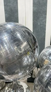 Chic modern silver metal globe with engraved world map details displayed ag.. Stock Photos