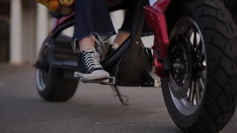 Chic rider gracefully gliding on a stylish scooter, showcasing an abundance Stock Footage 312983920