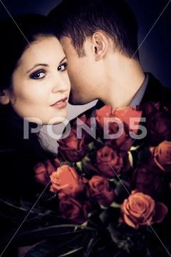 Chic Valentine's Couple With Bouquet Of Roses Stock Photos