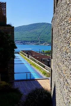 Chic views of the beach and the emerald lagoon, swimming pool between the walls Fotos Stock