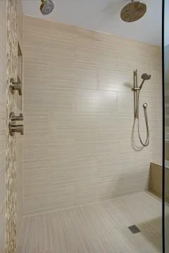 Chic Walk-in shower with built-in bench and beige subway tiled interior accen Stock Photos