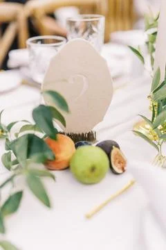 Chic wedding table number with fruit accents Stock Photos