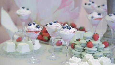 Chic white table with sweets for guests who came for the holiday. A wedding Stock Footage 123334208