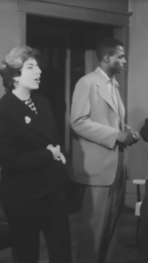 CHICAGO - 1959 - A black man corrects his friend who has told a date that jazz Stock Footage 342826962