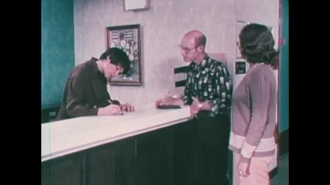 CHICAGO - 1970s - The receptionist asks the patient questions about his Stock Footage 340587134