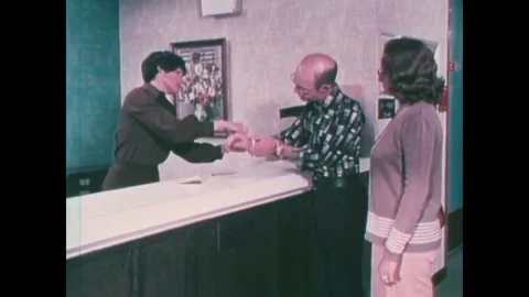 CHICAGO - 1970s - The receptionist puts an ID bracelet on the patient upon Stock Footage 340587117