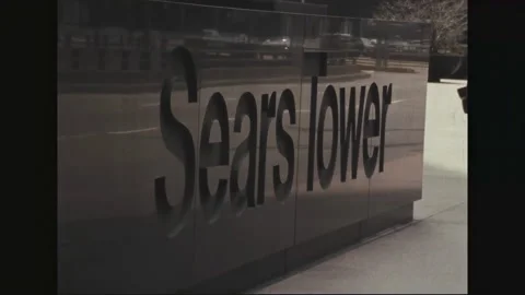 CHICAGO 1970s: Reflection of car on marble wall.  Sign.  Man points camera at Stock Footage 301907618