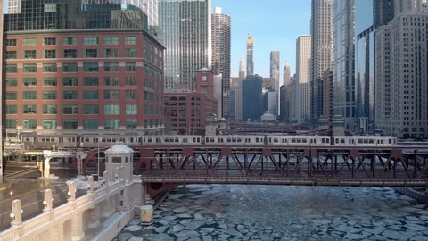 Chicago aerial skyline downtown buildings drone ice frozen river train winter Stock Footage