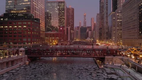 Chicago aerial skyline downtown buildings drone ice frozen river train winter Stock Footage