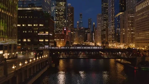 Chicago aerial skyline downtown buildings drone flying river bridge train night Stock Footage