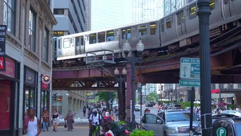 Chicago Elevated Train Passing Above Busy Downtown Street Stock Footage 336207302