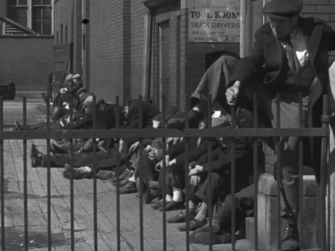 Chicago, IL - 1930s: Drunk man tries to scale fence Stock-Footage 231822322