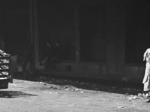 Chicago, IL - 1930s: Pushcarts and woman by loading dock Stock Footage 231820376