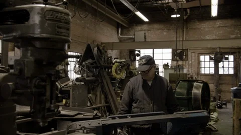 Chicago Interior Machine Works Shop Older Man pan Right Stock Footage 89996347