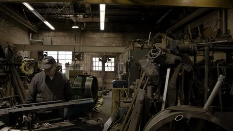 Chicago Interior Machine Works Shop Older Man Crash Zoom from Wide Shot Stock Footage 90000918