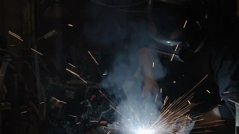 Chicago Interior Young Man Welding Tilt up from Sparks Stock Footage 89998743