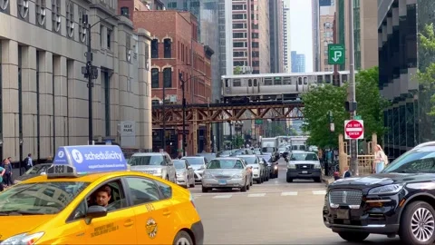 Chicago street view with Loop train - CHICAGO, UNITED STATES - JUNE 06, 2023 Stock Footage 244281092