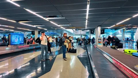 Chicago, USA, 7 May 2026: Crowded baggage claim area between two carousels, Stock Footage 336339065