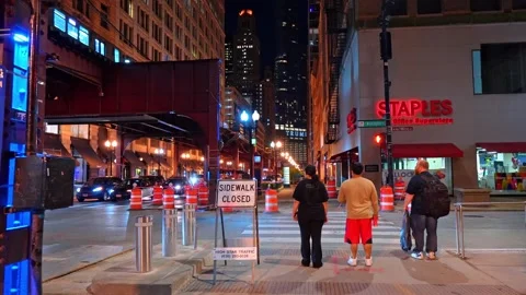 Chicago, USA, 7 May 2026: Street view of elevated train tracks at night, Chicago Stock Footage 336339381