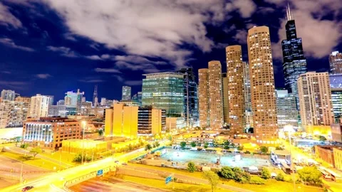 Chicagos skyline glows brightly at night with skyscrapers and city lights Stock Footage 312680550