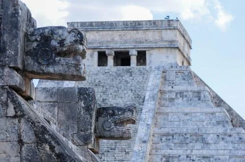 Chichen Itza's iconic pyramid with intricate carvings under clear sky Stock Photos