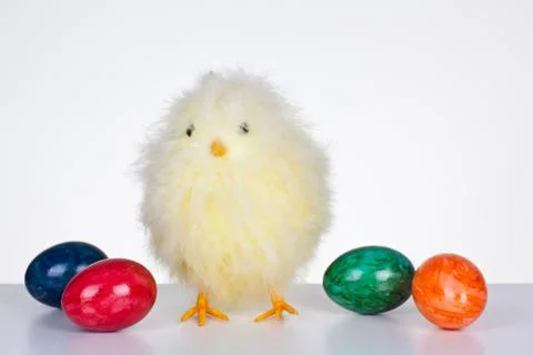 Chick figure with colored eggs Stock Photos
