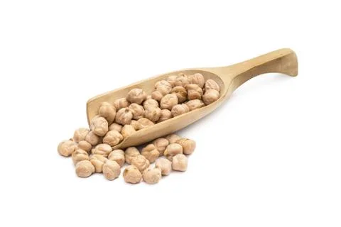 Chick peas on a spoon Stock Photos