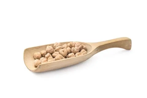 Chick peas on a spoon Stock Photos