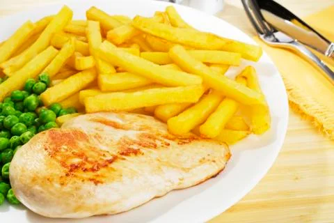 Chicken and chips dinner Stock Photos