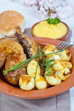 Chicken and potatoes Stock Photos