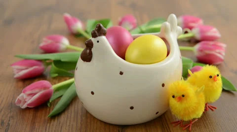 Chicken aside a chicken cup with easter eggs and tulip bunch 스톡 동영상 34267377