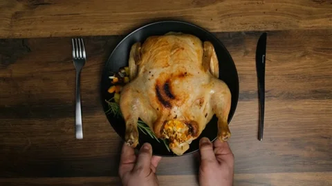 Chicken baked and stuffed with fruit is served on a black plate. top view Video stock 190327009