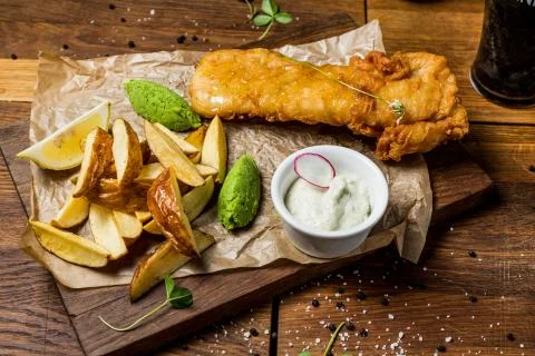 Chicken baked in batter with fried potatoes Stock Photos