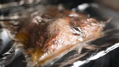 Chicken in a baking bag on a baking sheet in the oven. Stock Footage 250320298