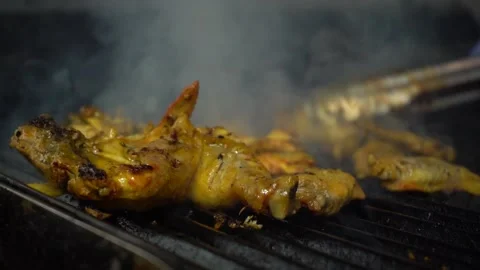 Chicken being flipped on grill Stock Footage 142881621