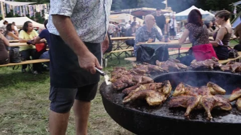 Chicken being turned around on a BBQ Stock Footage 162961268