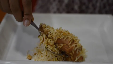 Chicken biriyani being served herself by a woman. Stock Footage