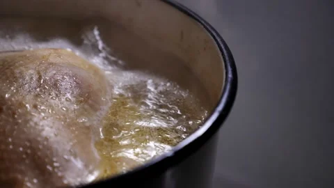 Chicken is boiling in a metal pot. Stock Footage 328613153