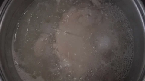Chicken boiling in a pot with hot water Stock Footage 77014253