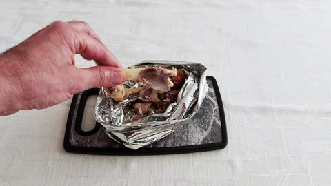 Chicken Bone in Hand: A Moment of Leftover Reality Video stock 311561569