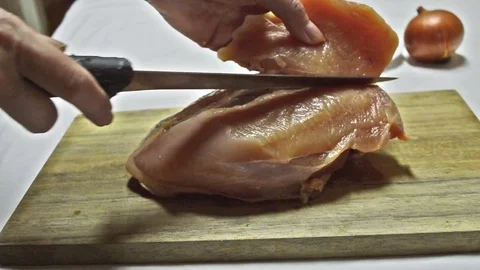 A Chicken Breast Being Sliced 2 Stock Footage 73681842