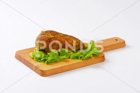Chicken breast fillet with spicy rub on wooden cutting board Stock Photos