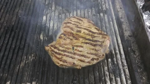 Chicken breast is fried on the grill in the kitchen of the restaurant Stock Footage 230319620