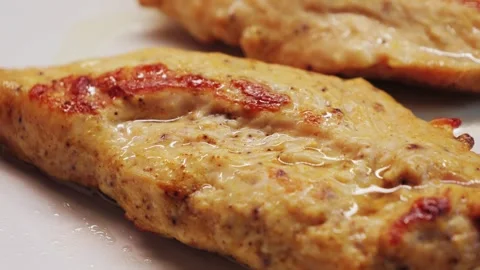 Chicken breast fried with spices. Appetizing close-up of the poultry with golden Stock Footage 334179560