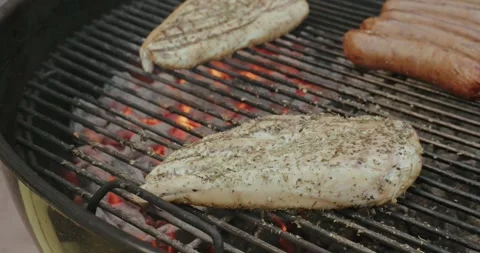 Chicken breast grilling on hot bbq Stock Footage 299660892